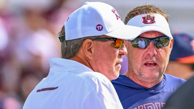 Hugh Freeze talks with  Texas A&M coach Jimbo Fisher.